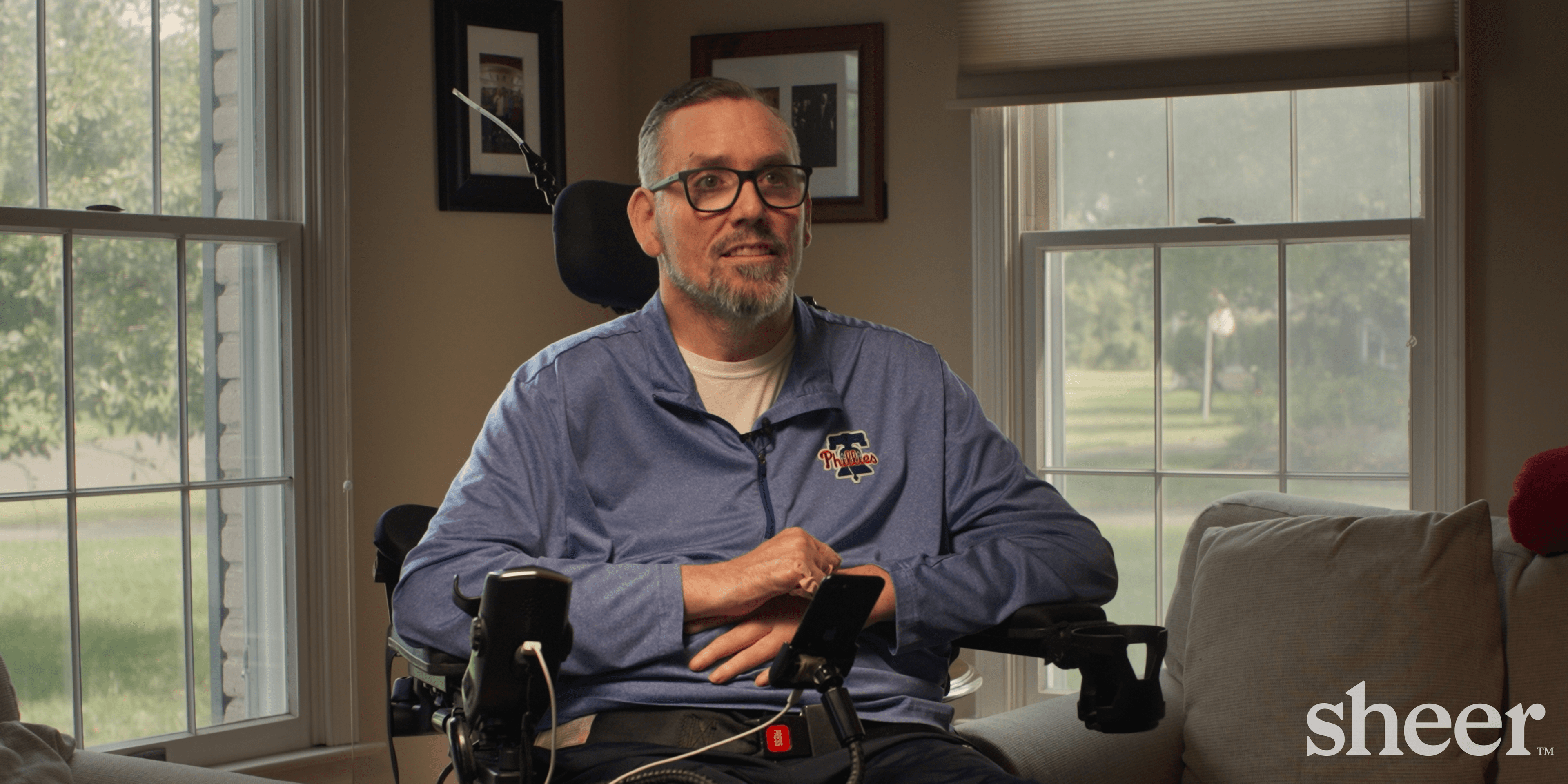 A quadriplegic man in a wheelchair, named Ryan Law, a Sheer Health member.